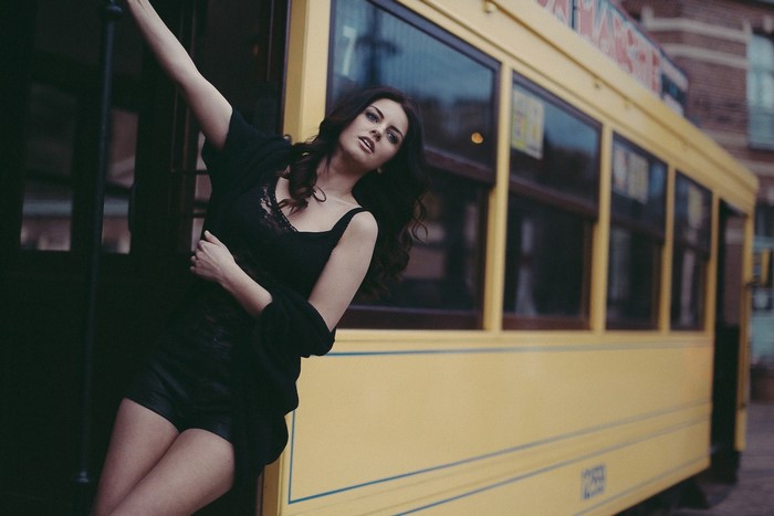 Aurela Skandaj leaning on a yellow tram