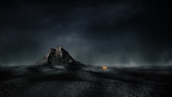 Dark mountain landscape with car headlights in mist