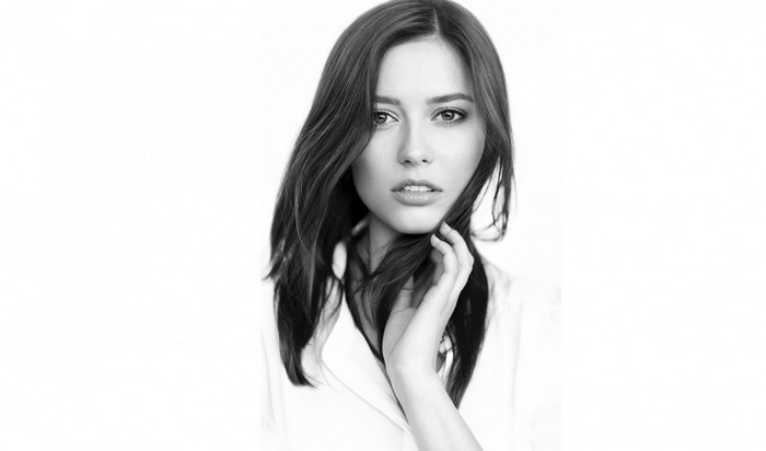 Monochrome portrait of a young woman with long brown hair