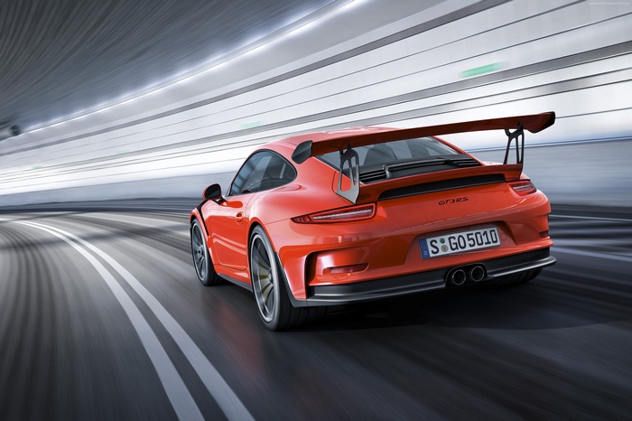 Orange Porsche 911 GT3 RS driving in a tunnel