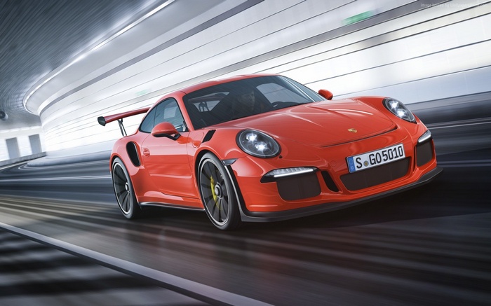 Red Porsche 911 GT3 driving through a tunnel