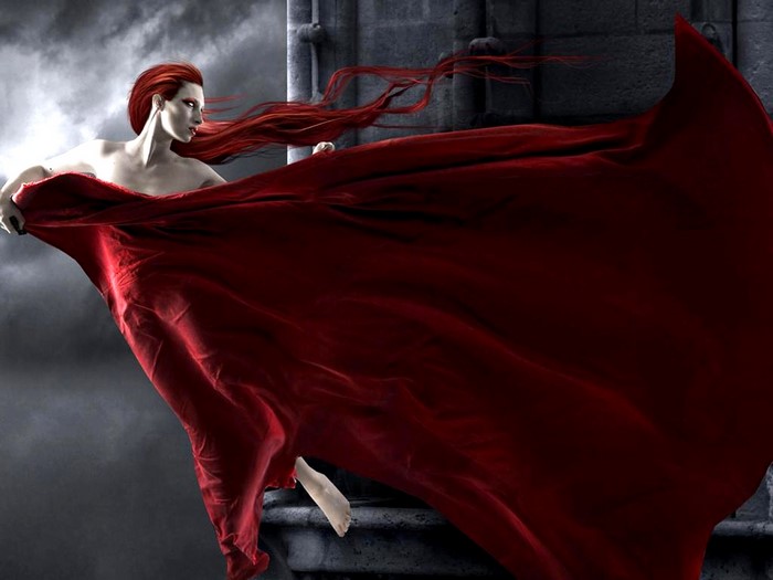 Woman with flowing red hair and red fabric