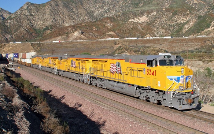 Yellow Freight Locomotives on Mountain Rail Track