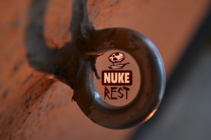 Close up of a metal eye bolt with a logo