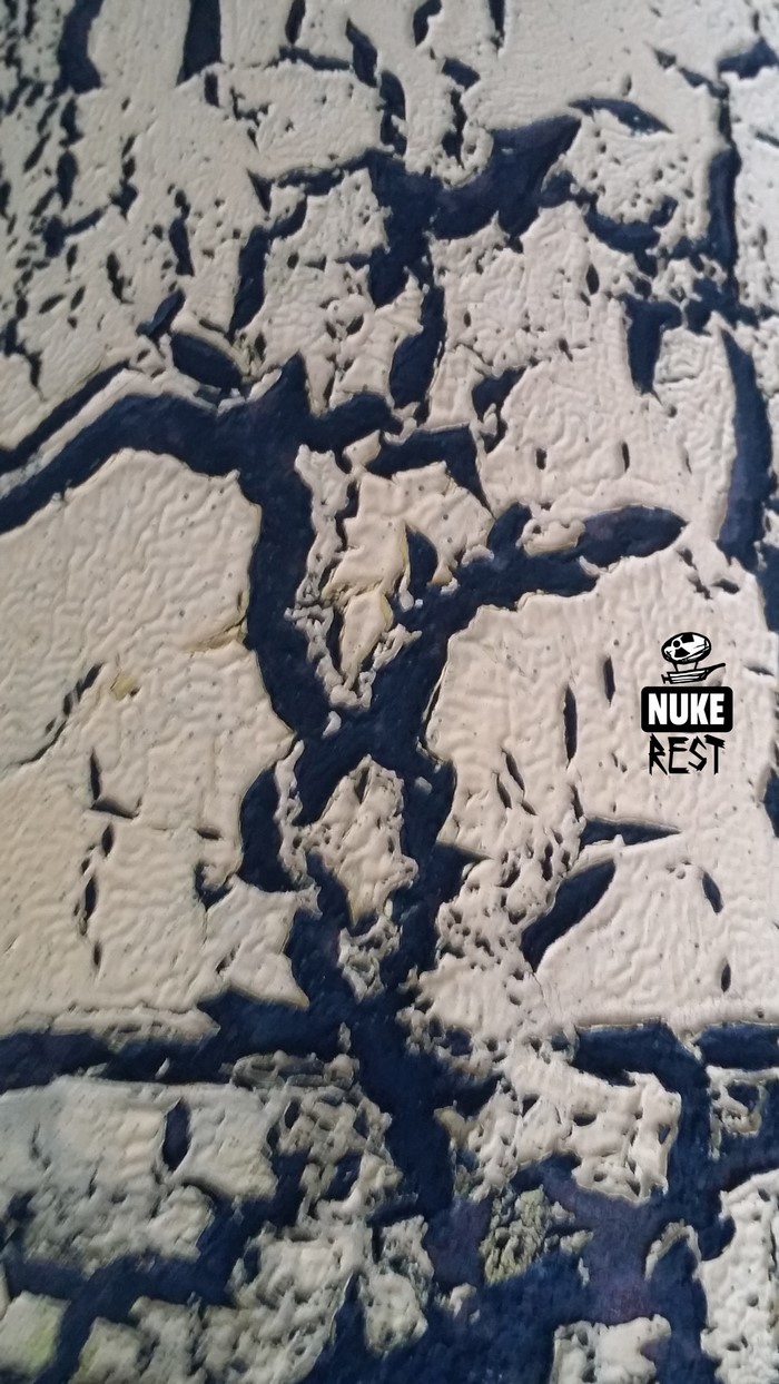 Close-up of cracked paint texture with logo