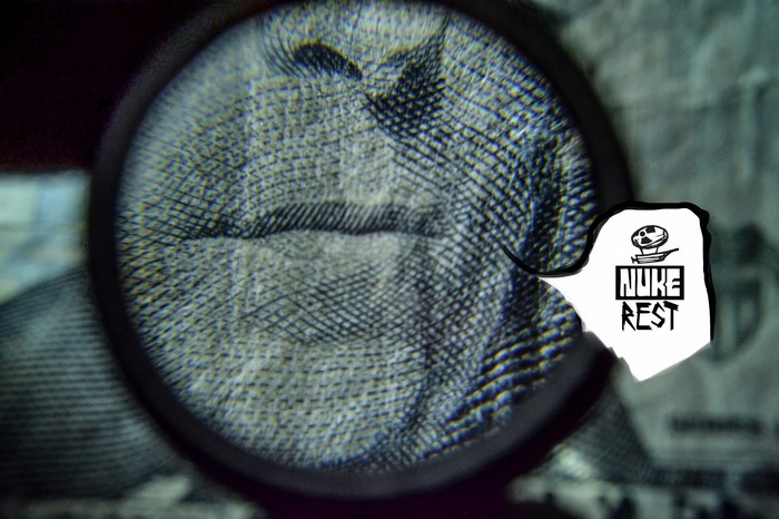 Magnified fingerprint on money with Nuke Rest logo