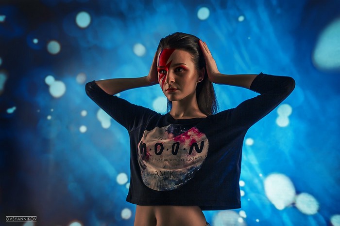Woman with red face paint and moon t-shirt