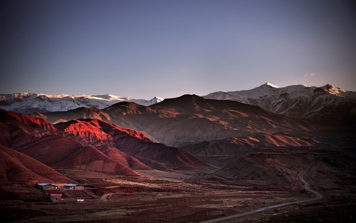Mountain landscape at sunset with snow-capped peaks