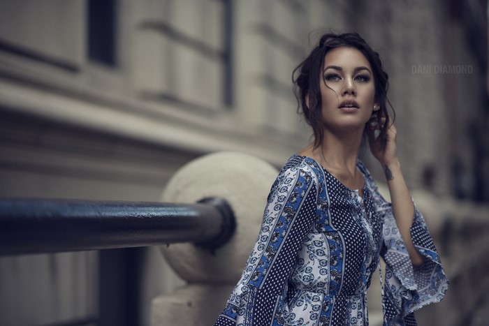 Woman in a blue and white dress posing outdoors