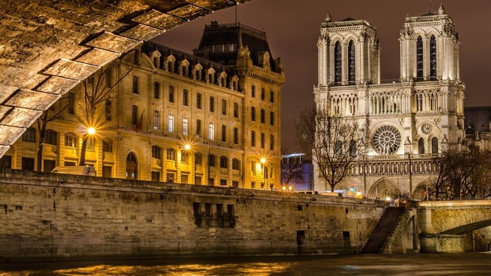 Notre Dame Cathedral and buildings at night in Paris