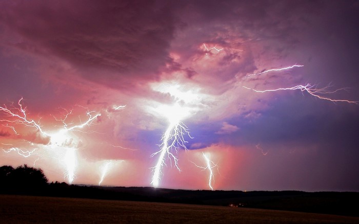 Multiple lightning strikes during a colorful thunderstorm