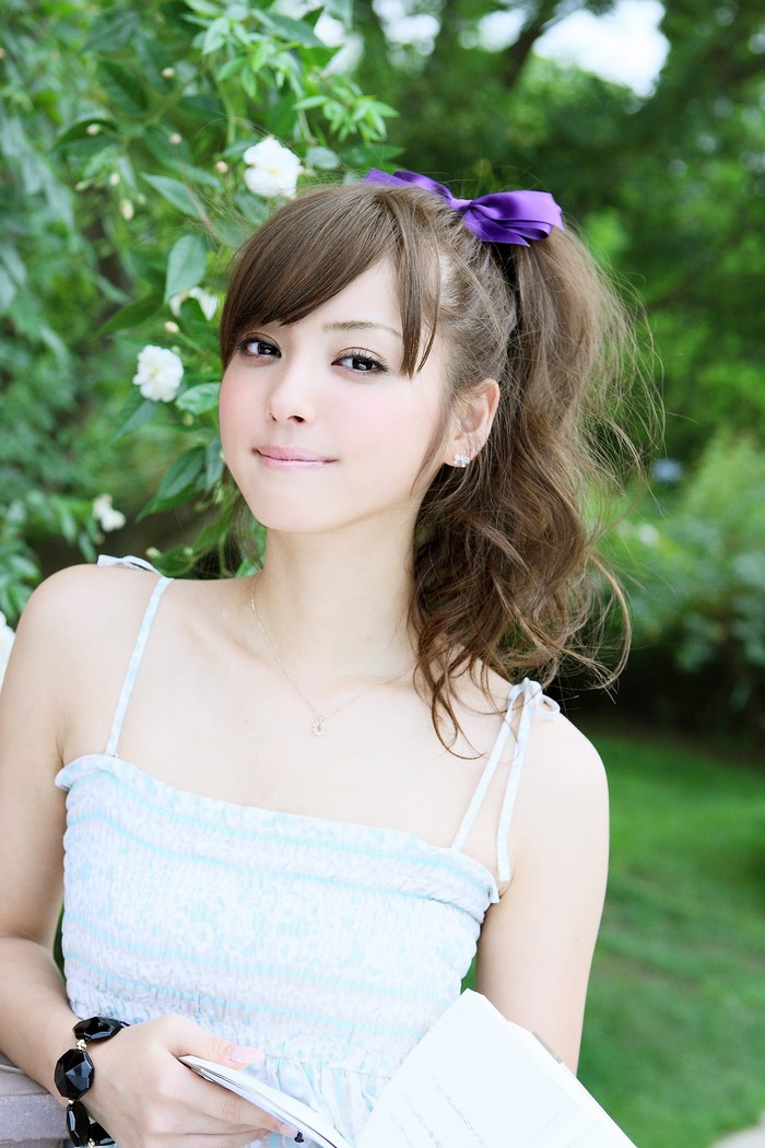 Portrait of a Woman with Long Brown Hair and Purple Bow