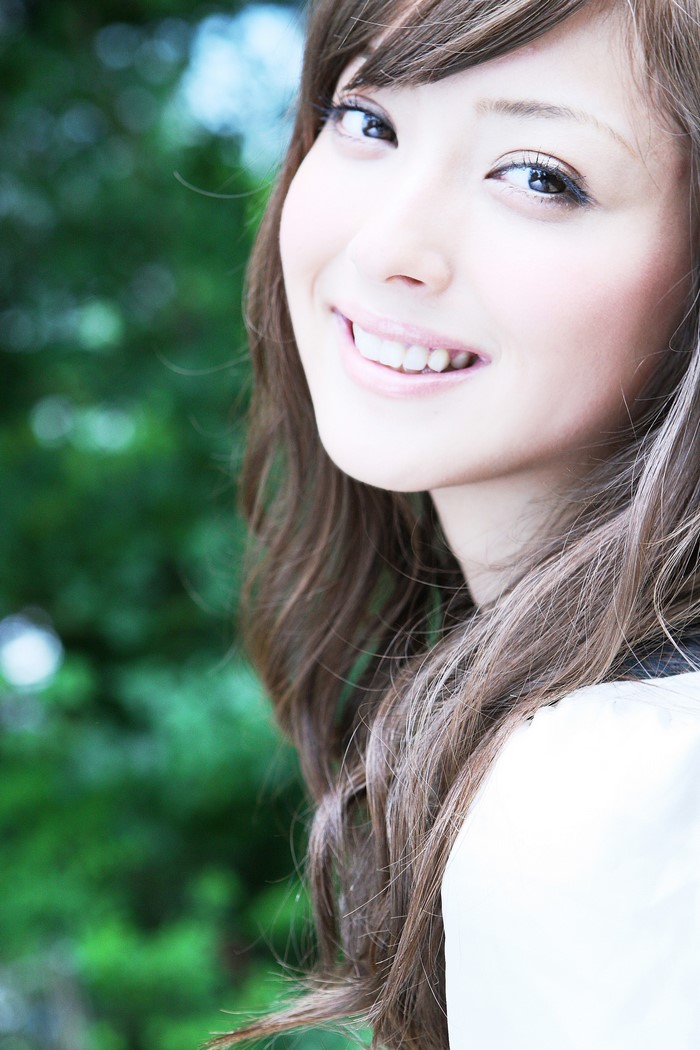 Smiling Young Woman with Long Brown Hair