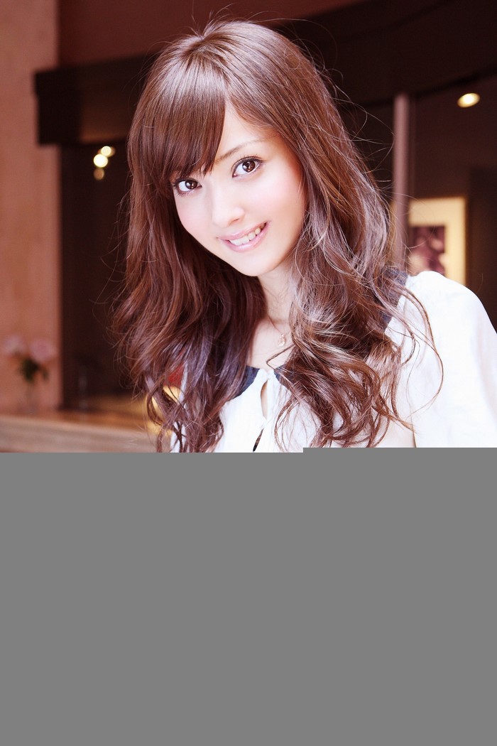 Portrait of Smiling Woman with Long Brown Hair