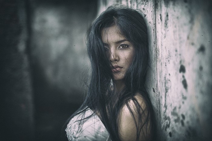 Woman leaning against a wall