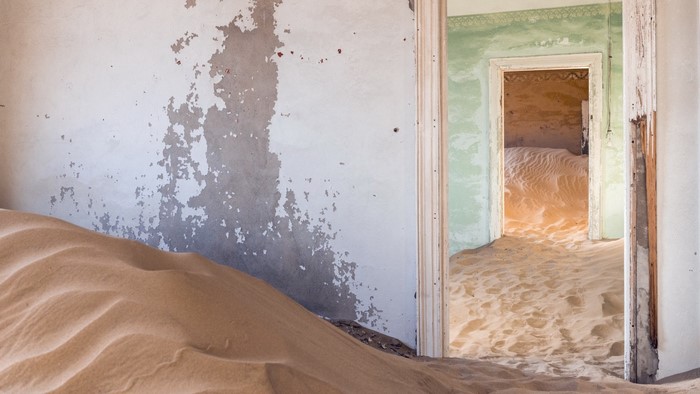 Abandoned building interior filled with sand