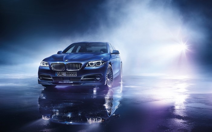 Blue BMW Alpina car with reflection on wet surface