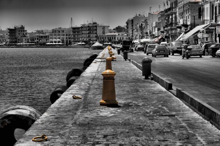Cityscape with a waterfront promenade and street traffic