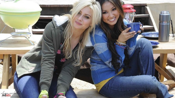 Alyson Michalka and Brenda Song sitting at a picnic table