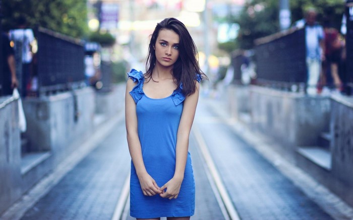 Young Woman in Blue Dress on City Street