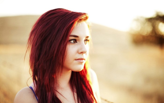 Portrait of a Young Woman with Red Hair in Sunlight