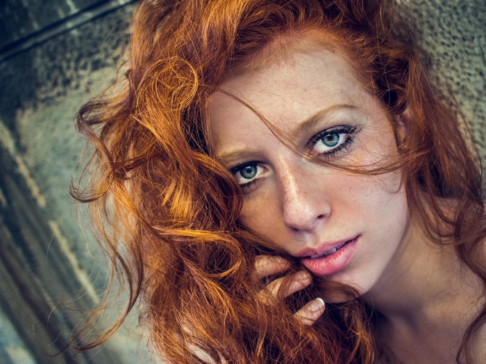 Close-Up Portrait of a Redhead Woman with Curly Hair