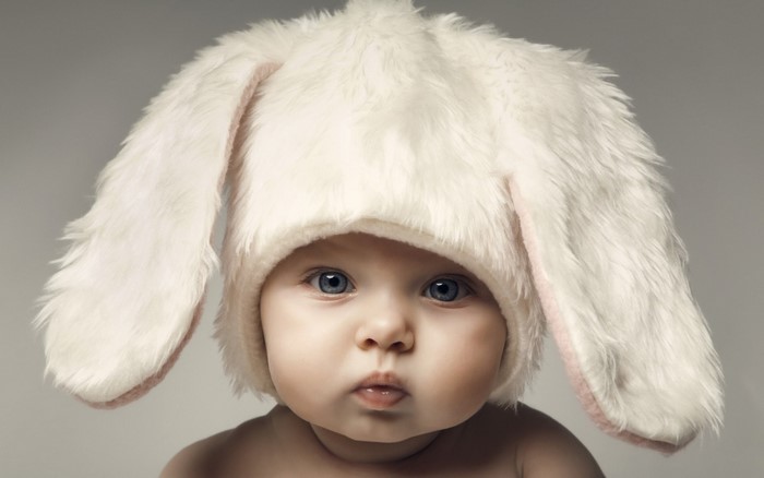 Baby wearing a white fluffy bunny hat