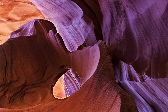 Antelope Canyon rock formations with purple and orange light