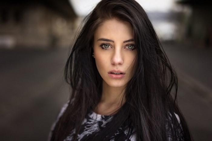 Portrait of Woman with Long Dark Hair and Blue Eyes