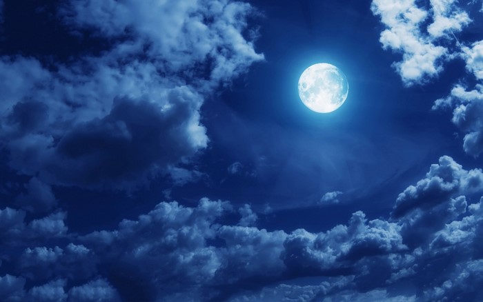 Full Moon Shining Through Night Clouds