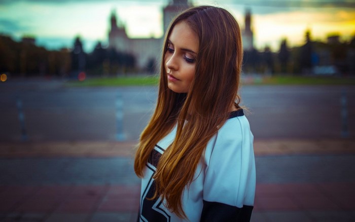 Young woman with long brown hair outdoors