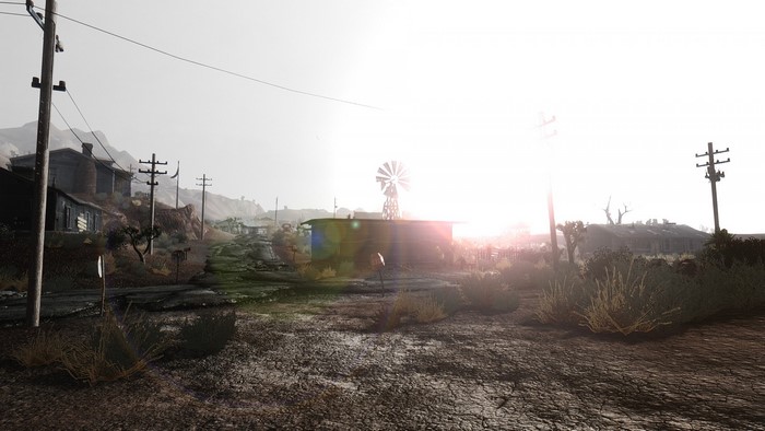 Post-apocalyptic town with a windmill at sunrise
