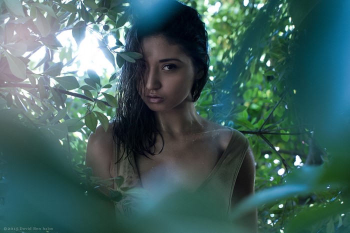 Woman in leaves with sunlight
