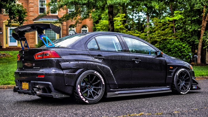 Black Mitsubishi Lancer Evolution X with large rear wing