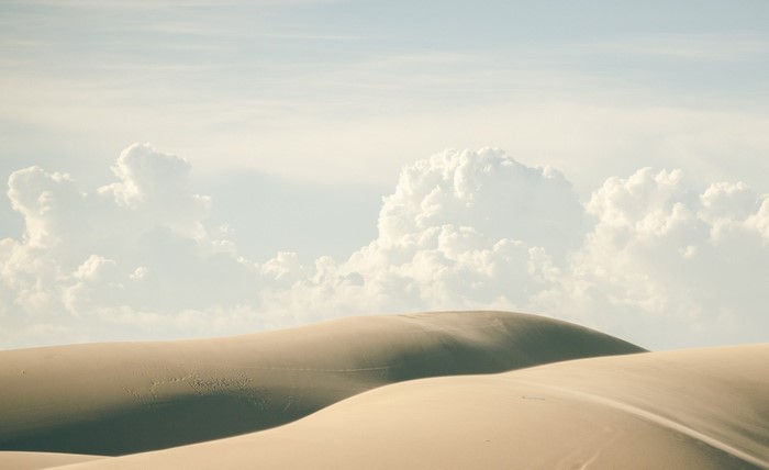 Sand dunes under a cloudy sky