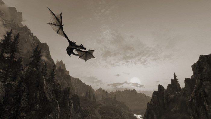 Dragon flying over mountains in The Elder Scrolls V Skyrim