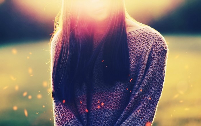 Woman in sweater with sunlight and bokeh