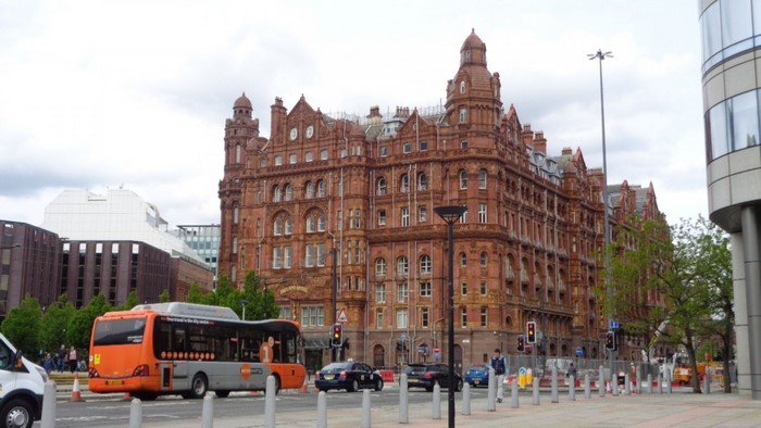 Orange bus and red brick building in a city