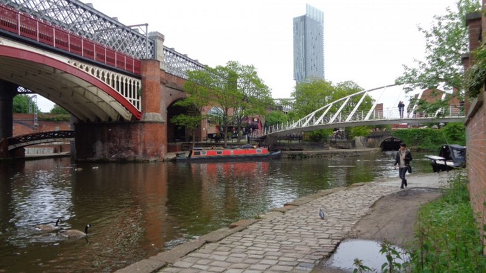 Canal with bridges and a skyscraper in Manchester