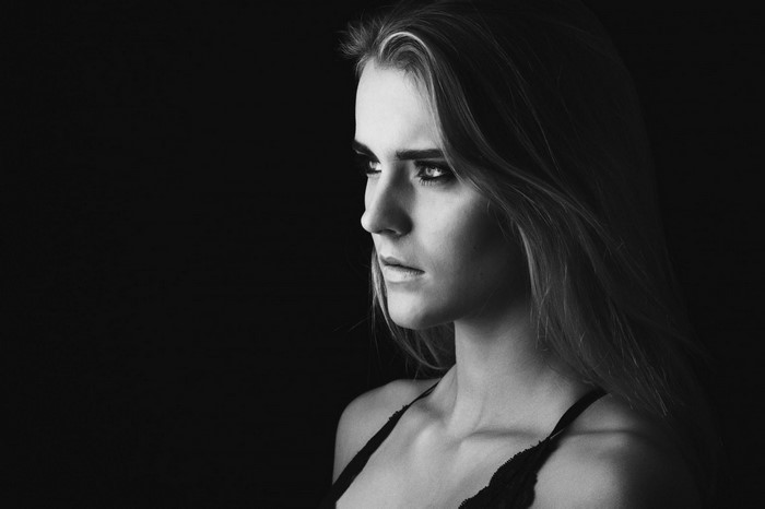Monochrome portrait of a woman with long hair looking away