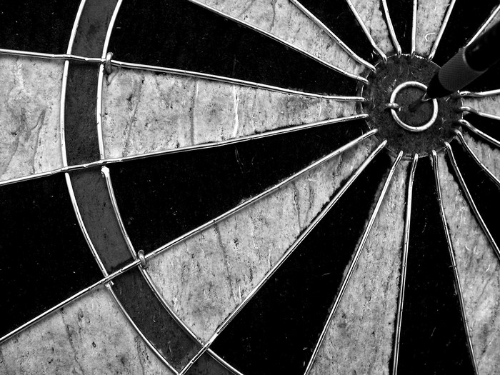Close-up of a dartboard with a dart in the bullseye
