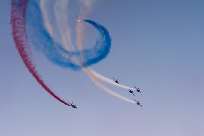 Patrouille de France jets performing aerobatics with colored smoke