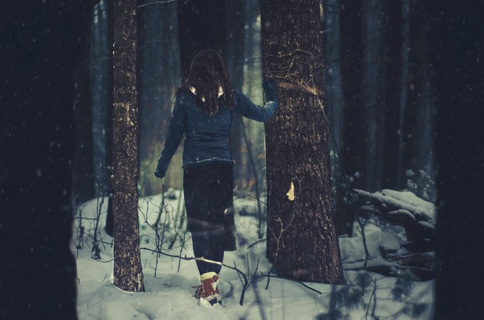 Woman walking in a snowy forest