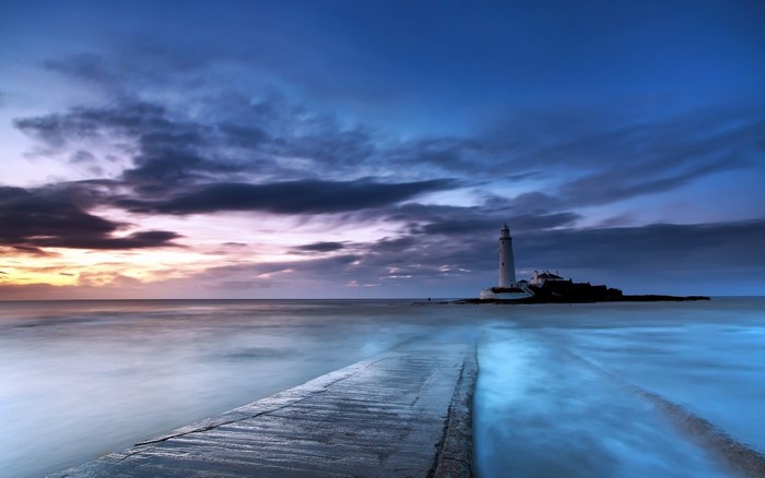 Sunset Over Tranquil Lighthouse and Ocean Path