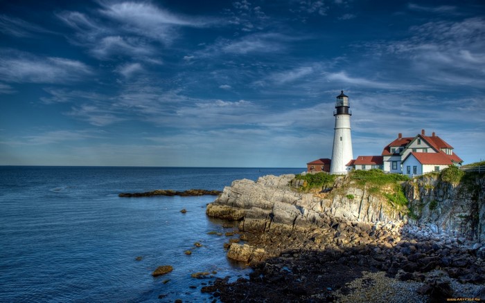 Coastal Lighthouse on Rocky Cliff at Dusk