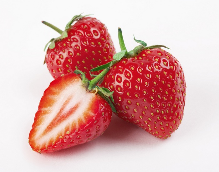 Three strawberries, one cut in half