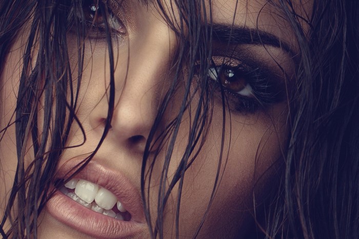 Close up of a woman's face with wet hair