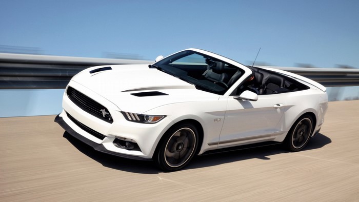 White Ford Mustang GT Convertible driving on a road