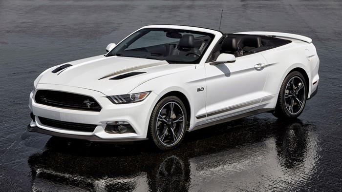 White Ford Mustang Convertible parked on wet asphalt