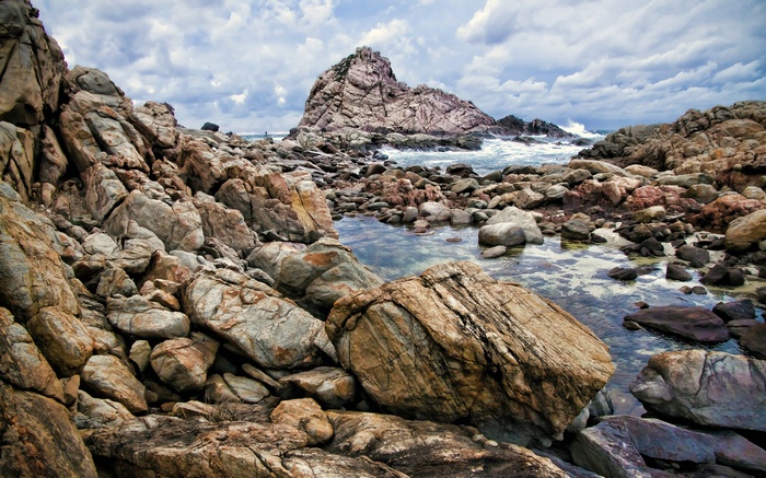 Rocky coastline with large rock formations and ocean waves